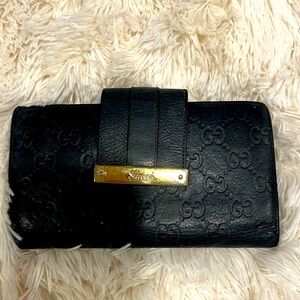 Authentic Gucci Guccisima black leather wallet with gold hardware.